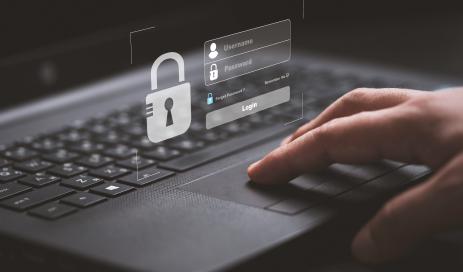 An attacker sits at a laptop and attempts to login to another application using stolen login credentials.