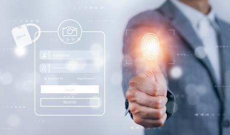 A user is accessing his personal account by pressing his thumb on the biometric reader next to the virtual login screen with username and password.