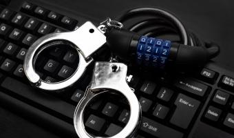 Directors risk personal liability and locked handcuffs which lie on a keyboard of this picture if they do not comply with data privacy regulation.