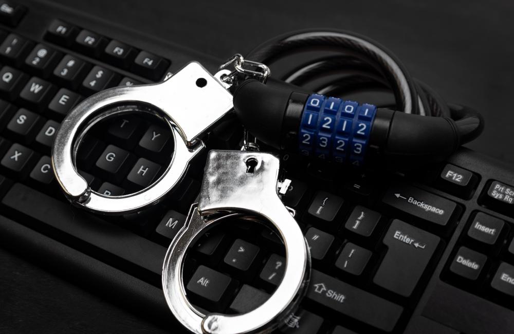 Directors risk personal liability and locked handcuffs which lie on a keyboard of this picture if they do not comply with data privacy regulation.