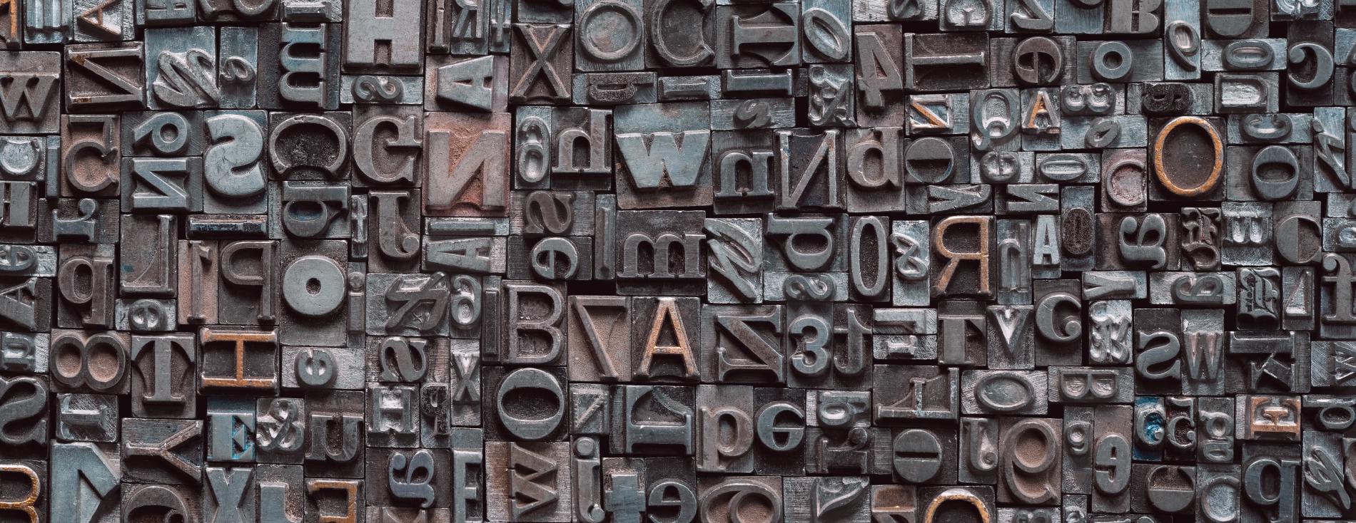 Close up of many old, random metal letters with copy space.